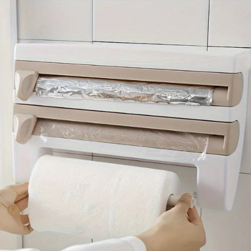 Person using a plastic wrap dispenser with multiple rolls on a tiled wall.