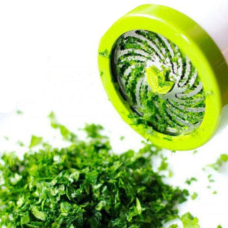green and white herb grinder grinding herbs