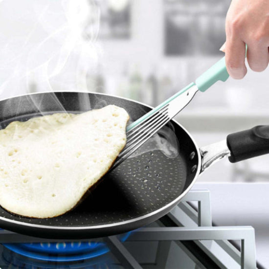 non-stick silicone edge spatula lifting a pancake in a pan