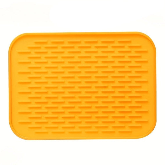 Orange silicone mat with textured surface on a white background