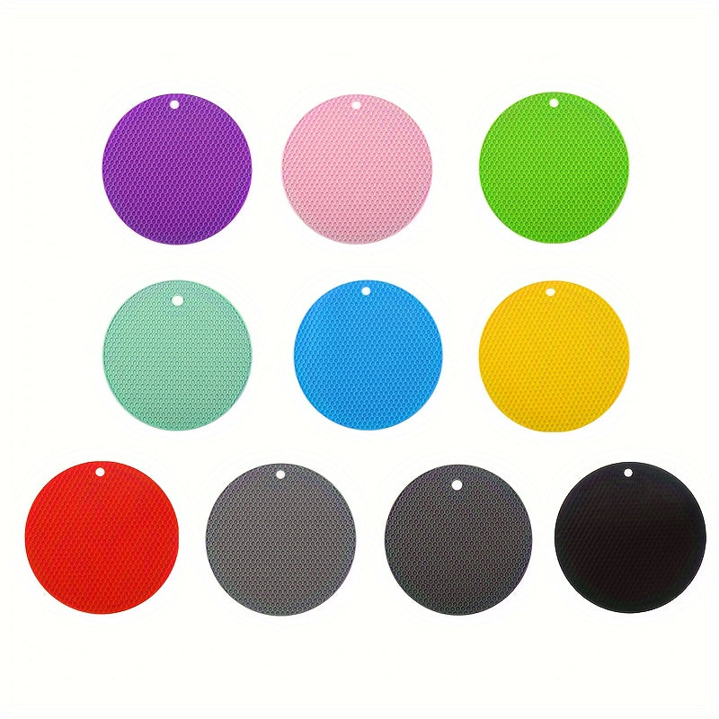 Colorful round silicone mats in various colors on a white background