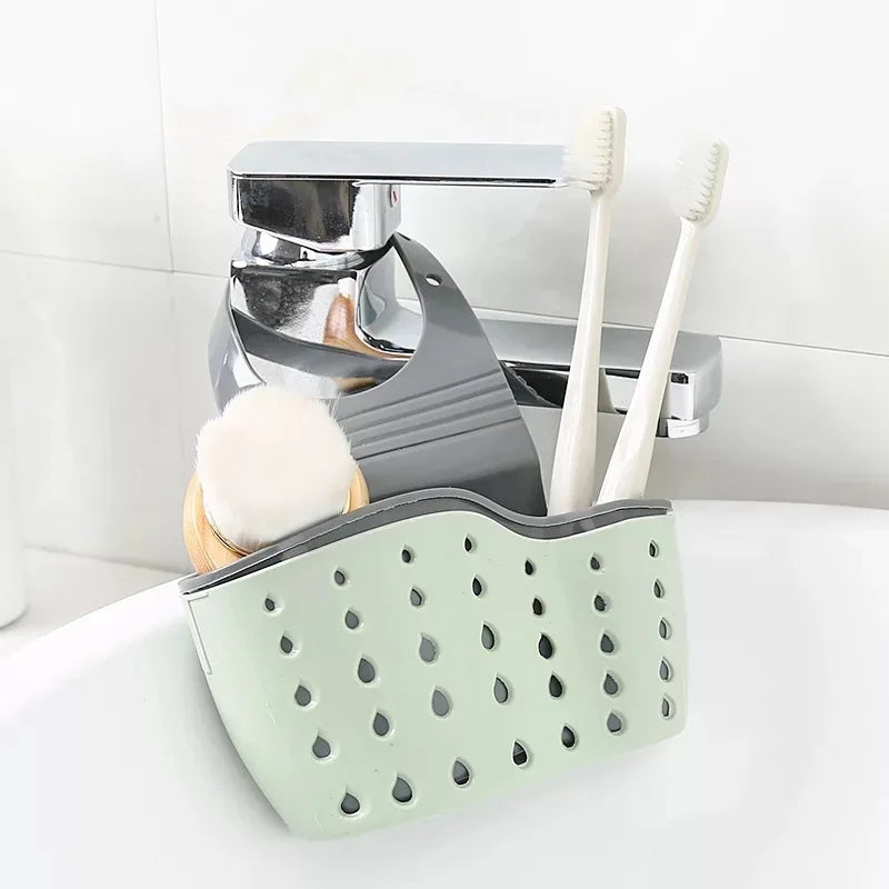 green silicone sink caddy with holes connected to a tap with two toothbrush