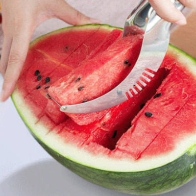 person slicing watermelon with a silver melon cutter