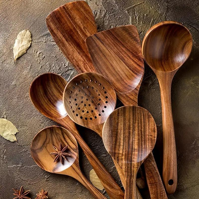 Set of wooden kitchen utensils on a textured surface with leaves and stars.