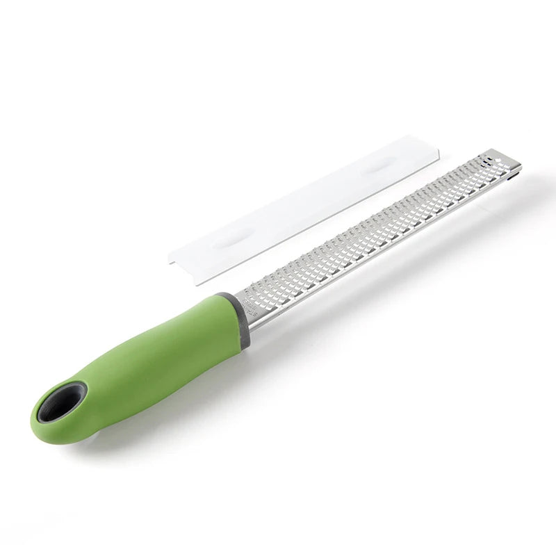 Green-handled zester on a white background