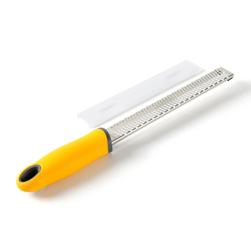 Zester with yellow handle and metal blade on a white background