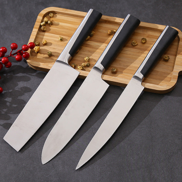 3 Stainless Steel knives on a chopping board