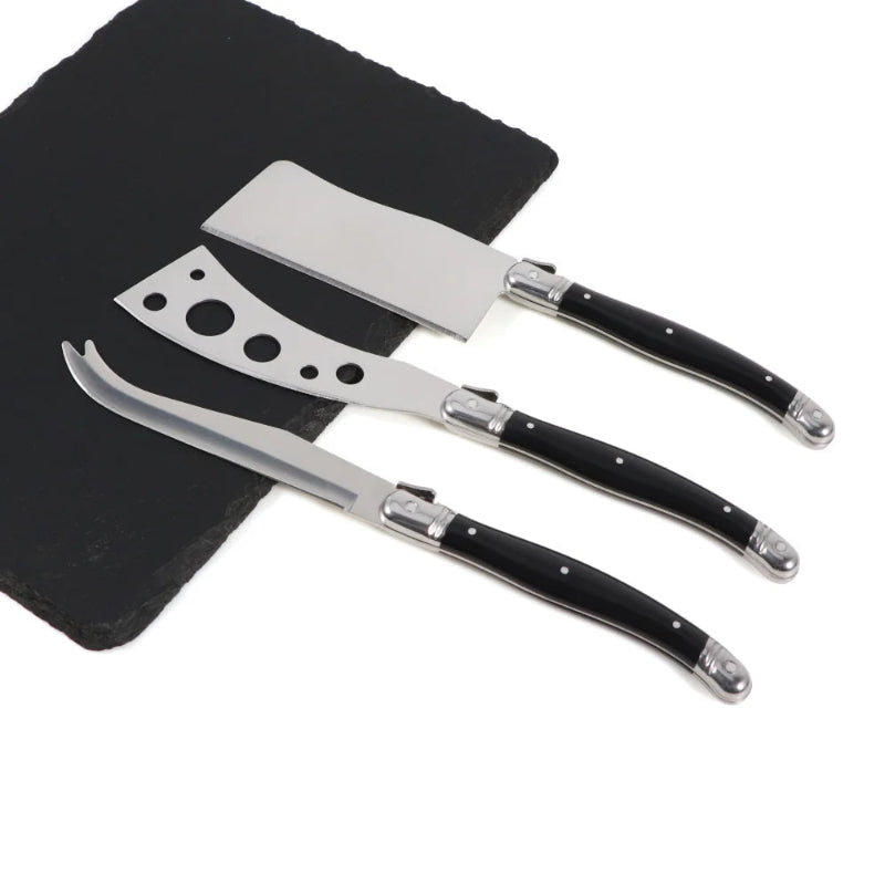 Set of three cheese knives with black handles on a white background