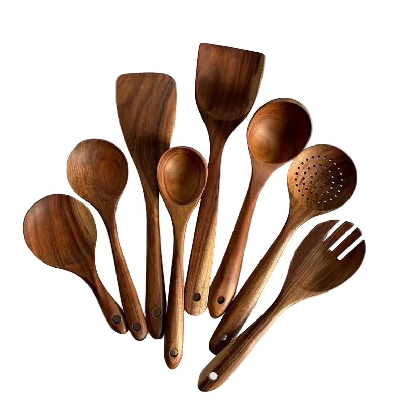 Set of wooden kitchen utensils including spoons and a spatula on a white background