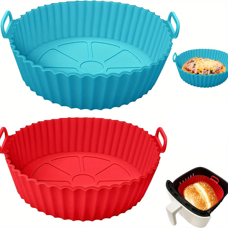 Blue and red silicone air fryer inserts with handles on a white background