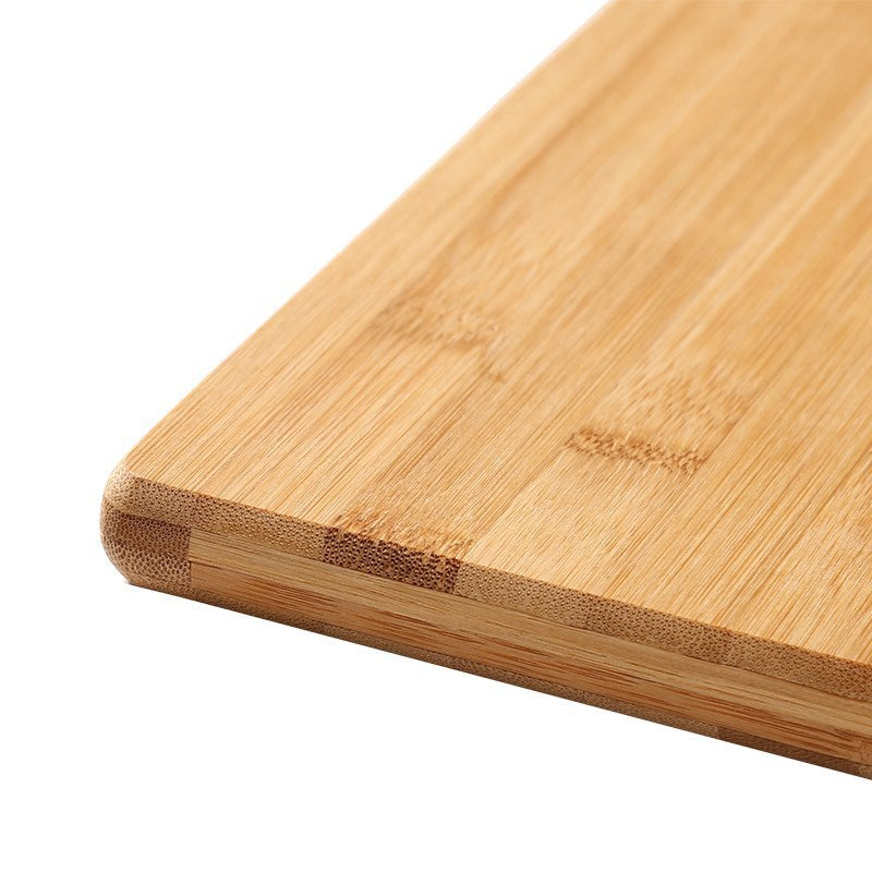 Close-up of a bamboo cutting board on a white background