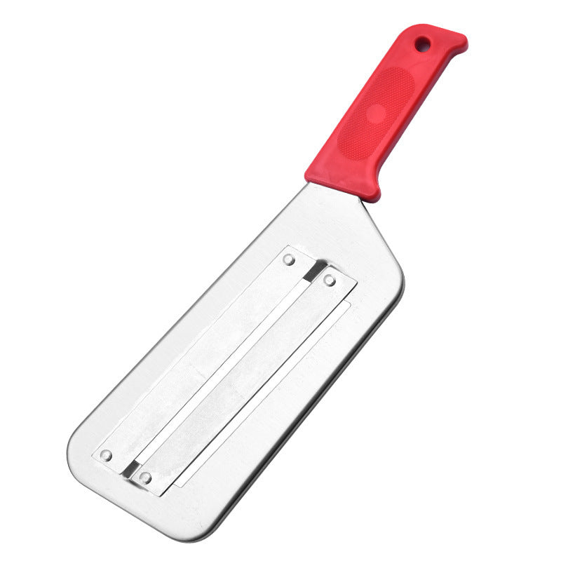 Metal cabbage shredder with a red handle on a white background