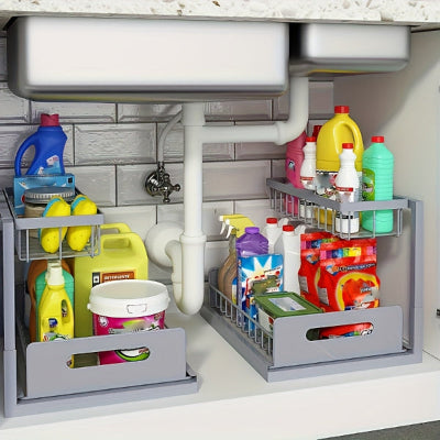 two grey slide out kitchen caddies under a kitchen sink