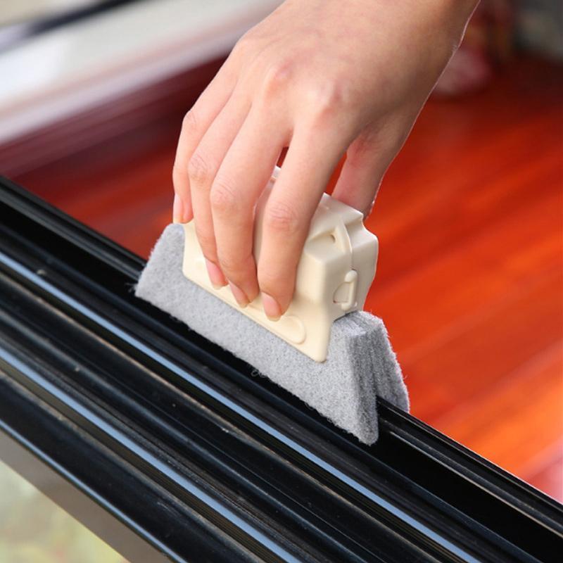 person cleaning a window slot with a white handle slot cleaner