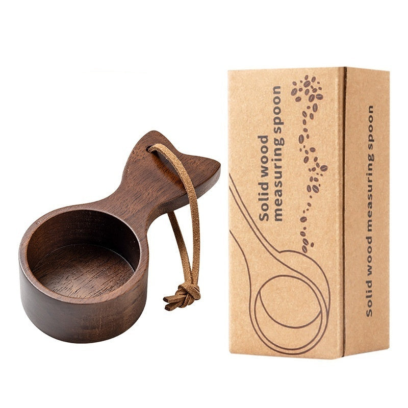 Wooden measuring spoon with a cardboard box on a white background