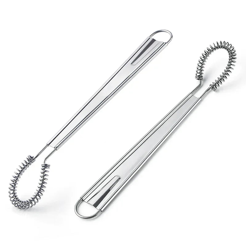 Stainless steel egg whisk with coiled design on a white background