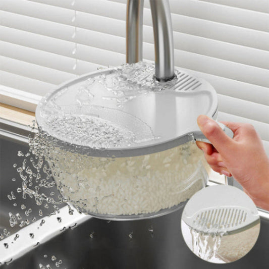 person rinsing rice in a round transparent bowl with a grey strainer lid