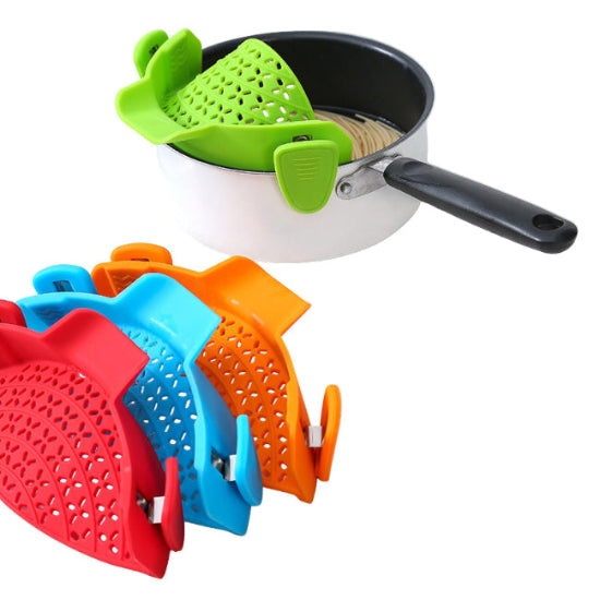 pot with a green clip on drainer with a red, orange and blue drainer in the corner
