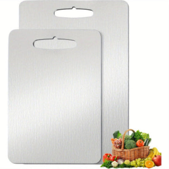Two silver cutting boards with a basket of fruits and vegetables on a white background