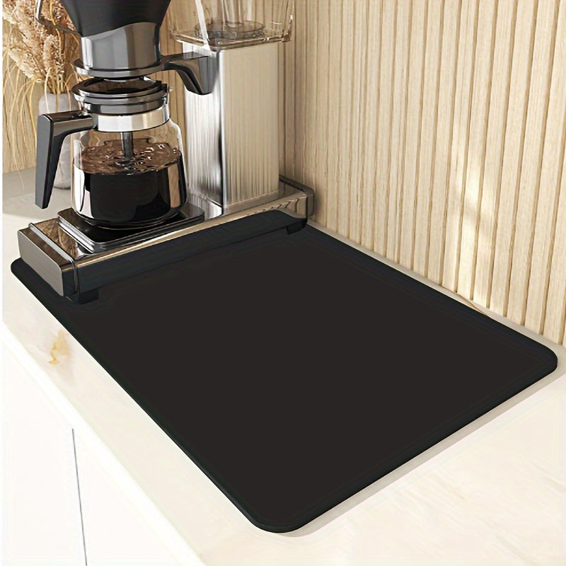 Black mat on a kitchen counter with a coffee maker in the background