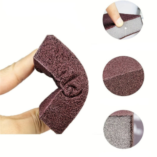 Purple emery sponge with a hand holding it, showing its flexibility and design details.
