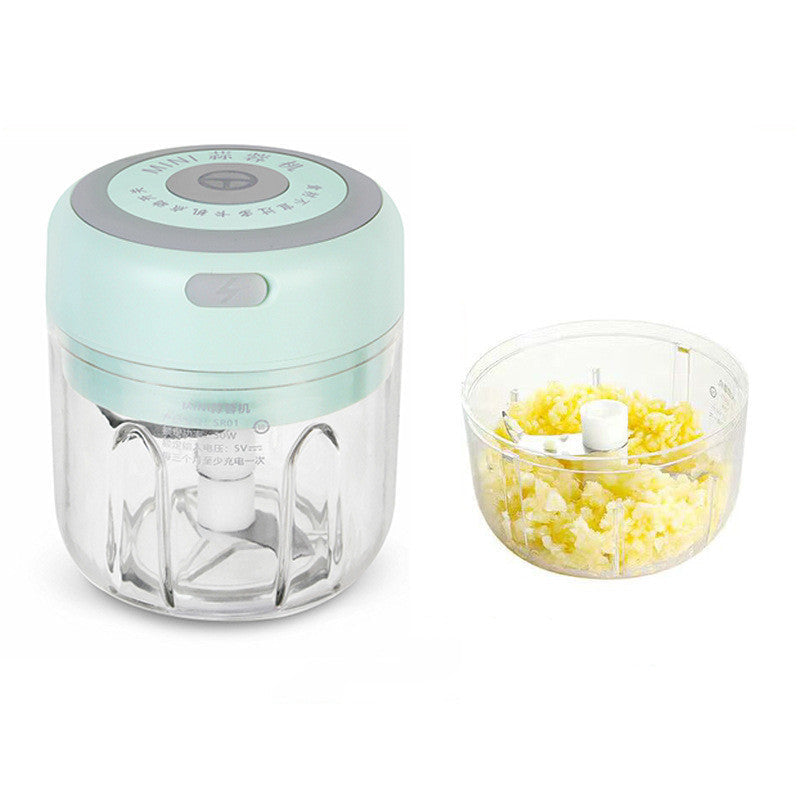 Blue food chopper with a container of chopped vegetables 