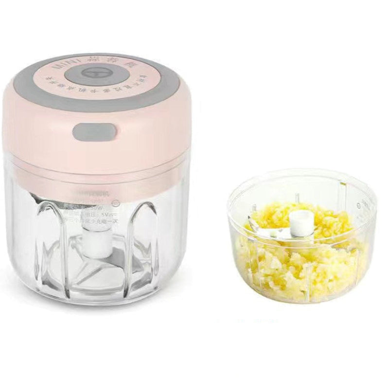 Pink food chopper with clear container on a white background