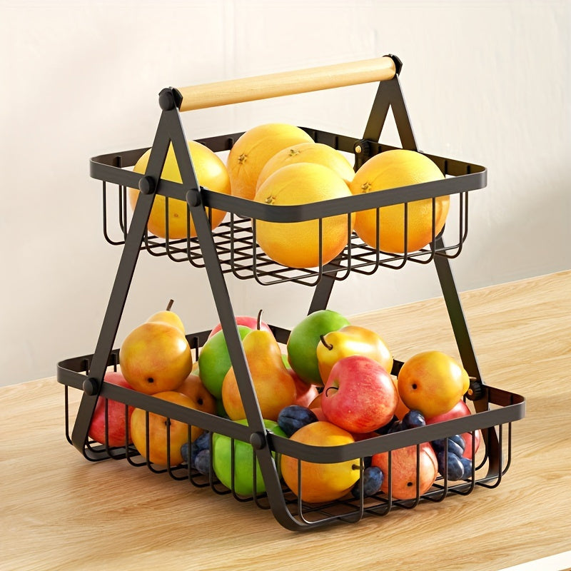 Two-tiered metal fruit basket with fruits on a wooden table