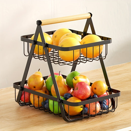Two-tiered metal fruit basket with fruits on a wooden table