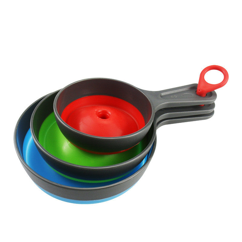 Set of colorful measuring cups with a red handle on a white background
