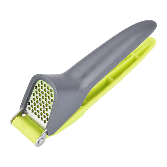 grey garlic press with green handle