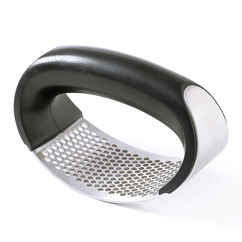 Handheld metal grater with black and white handle on a white background