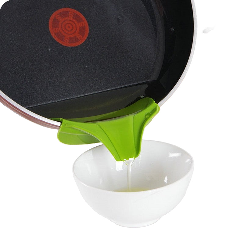 green clip on pan pourer pouring oil into a white dish