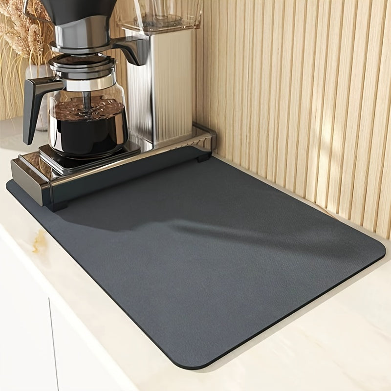 Gray mat on a kitchen counter with a coffee maker in the background