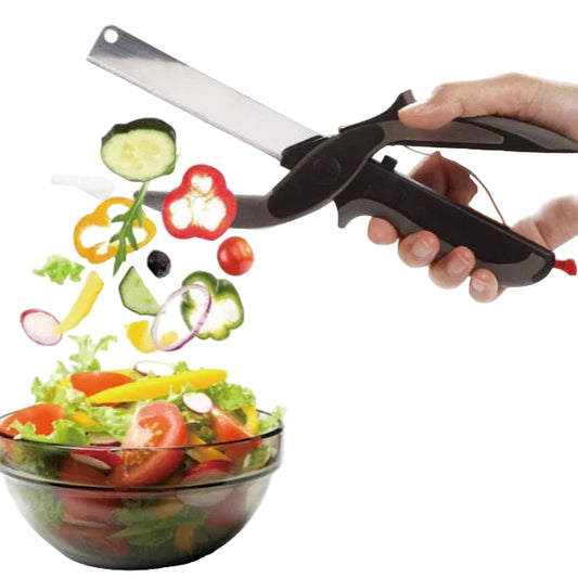 kitchen shears cutting salad ingredients with a bowl of salad