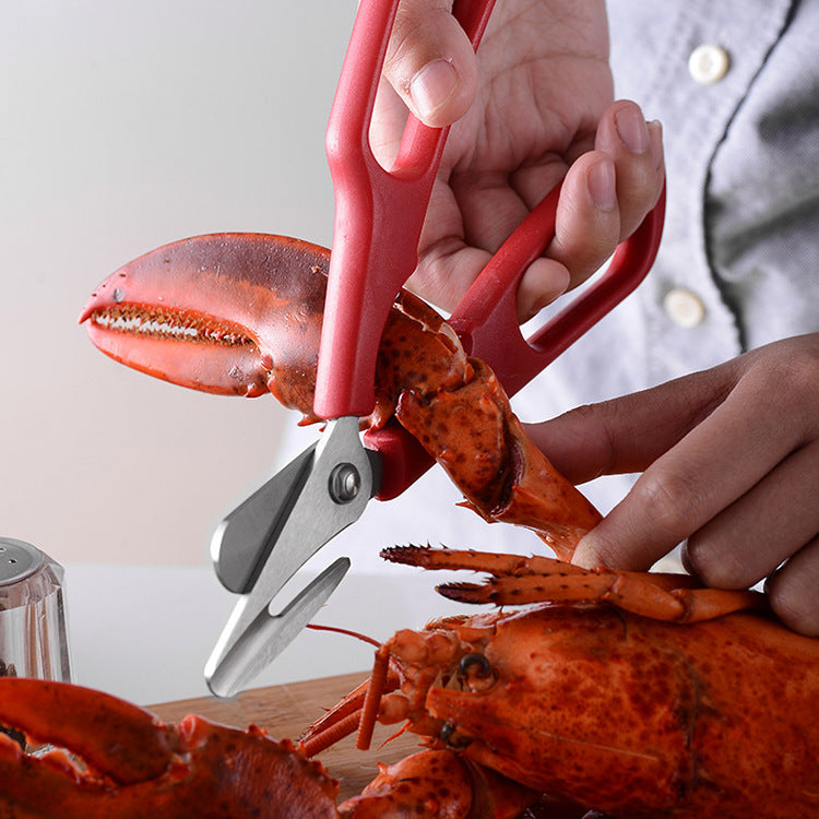 person cracking lobster claws with shellfish scissors