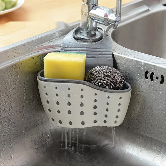silicone kitchen sink caddy with sponge and steel wool tied onto a faucet