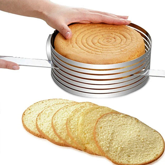person slicing cake in a steel cake cutter ring with cake slices lying beside it