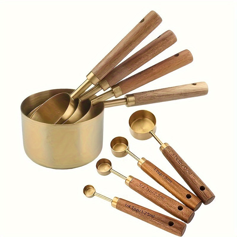 Set of brass measuring cups and spoons with wooden handles on a white background