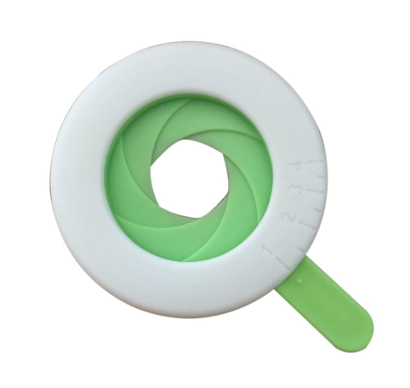 white and green circular measuring tool on a white background