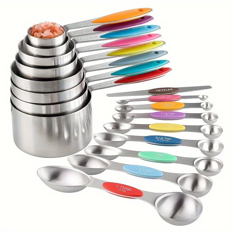 Set of stainless steel measuring spoons with color-coded handles on a white background