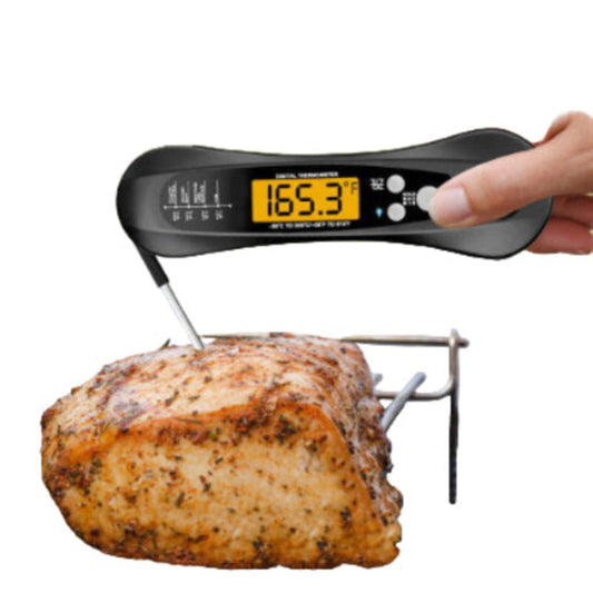 black digital meat thermometer checking temperature of roasted meat