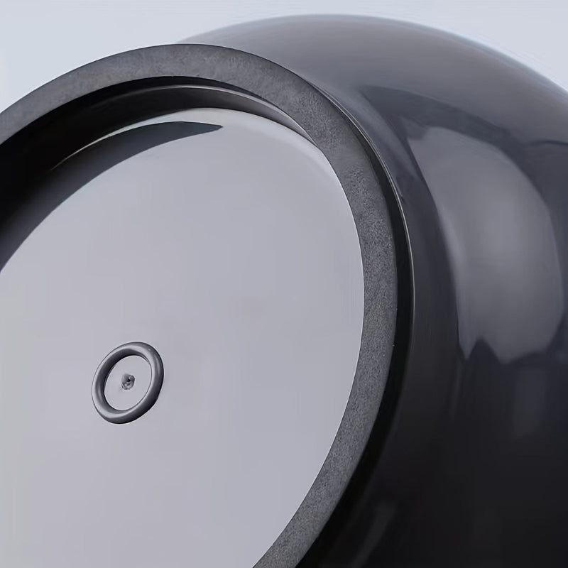 Close-up of a black and gray ceramic bowl with a smooth finish.