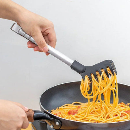 Person using a black and silver pasta server to serve spaghetti from a pan.