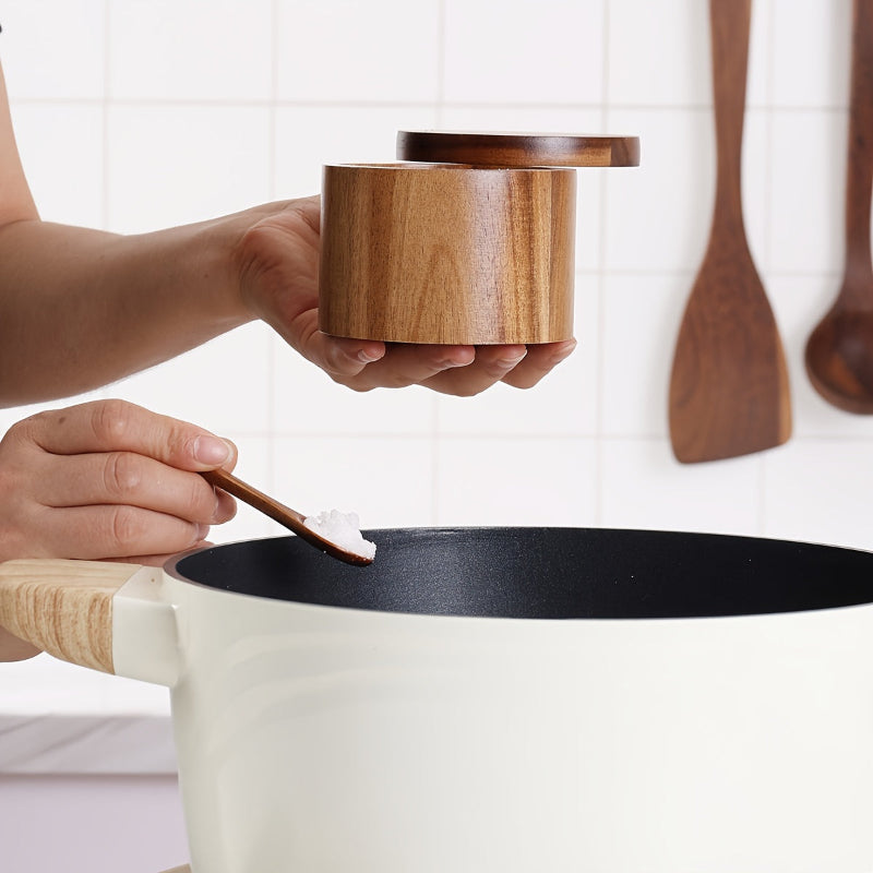 Person using a wooden spoon to scoop something from a container into a pot.