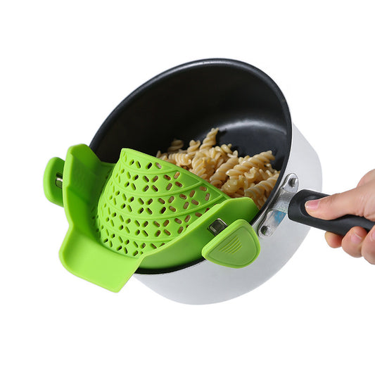 person holding a pot with a green clip on drainer