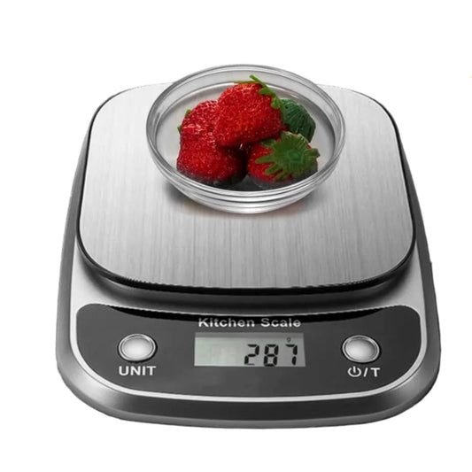 Digital kitchen scale with a bowl of strawberries on a white background