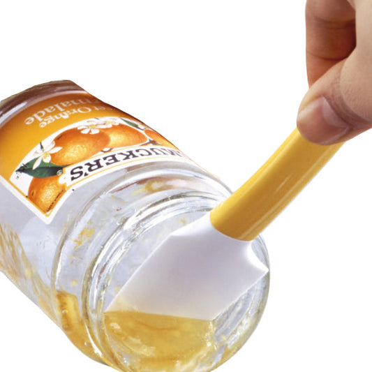 person with a yellow and white silicone scraper scraping jam out of a jar