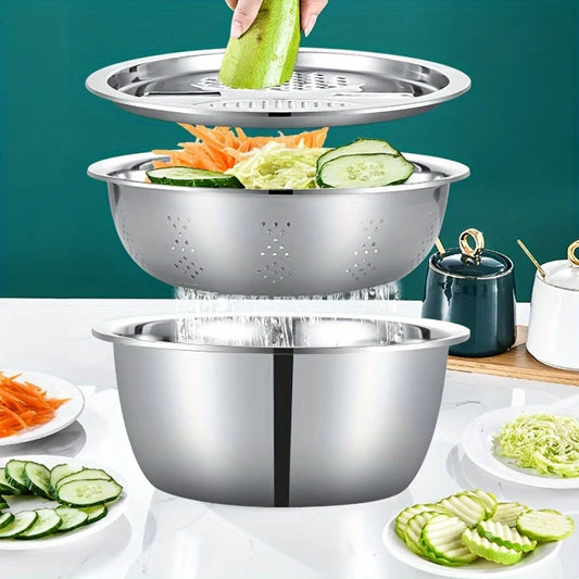 Stackable stainless steel bowls with vegetables on a white surface against a teal background
