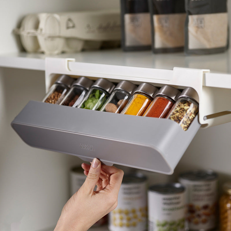 suspended spice jar rack on a kitchen cabinet shelf